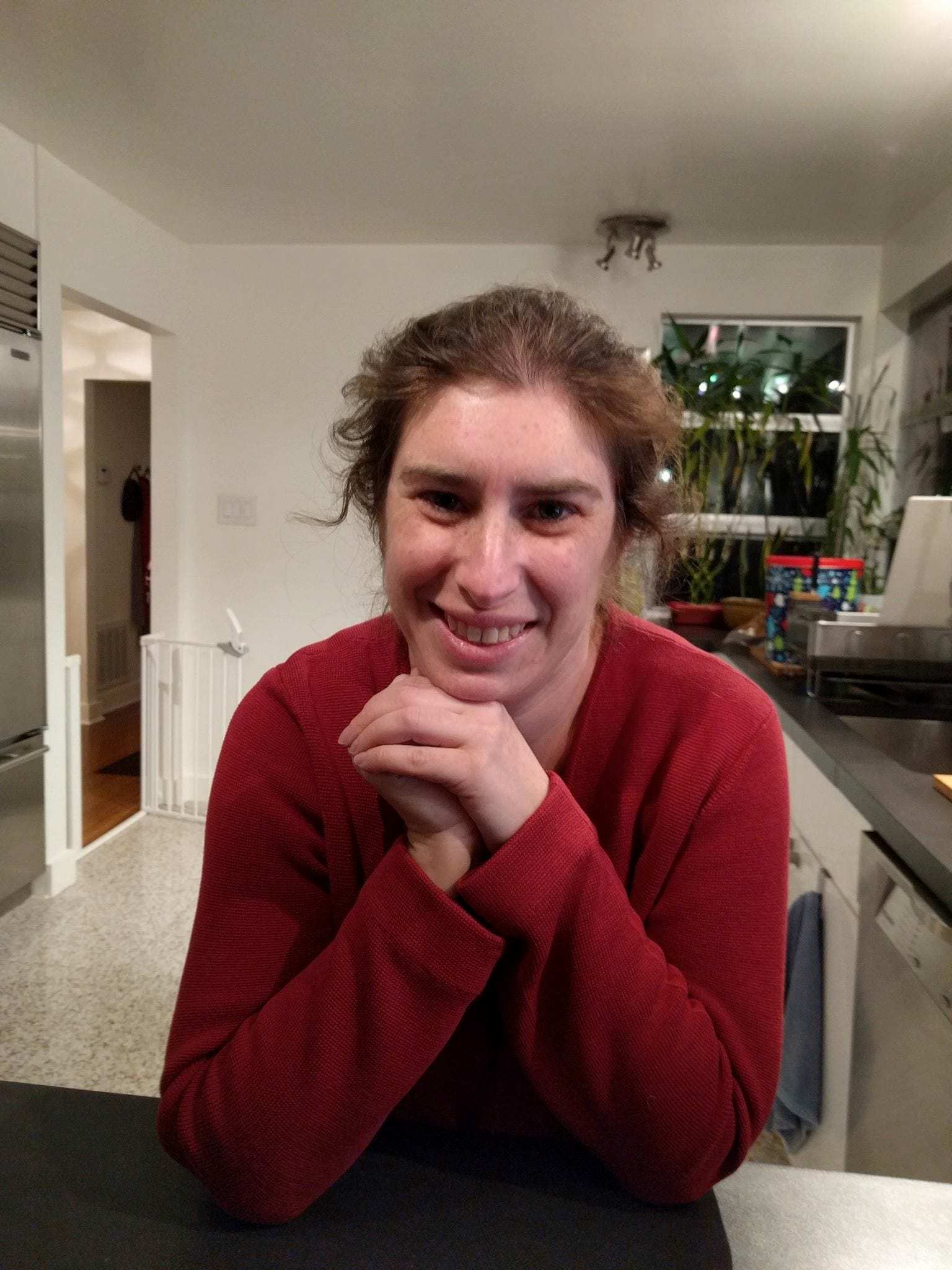 Becca smiling in kitchen.