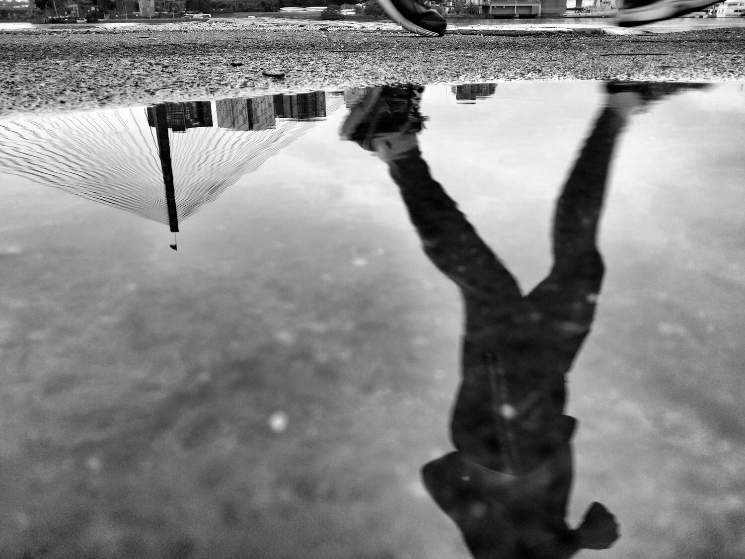 Water reflecting a person walking.