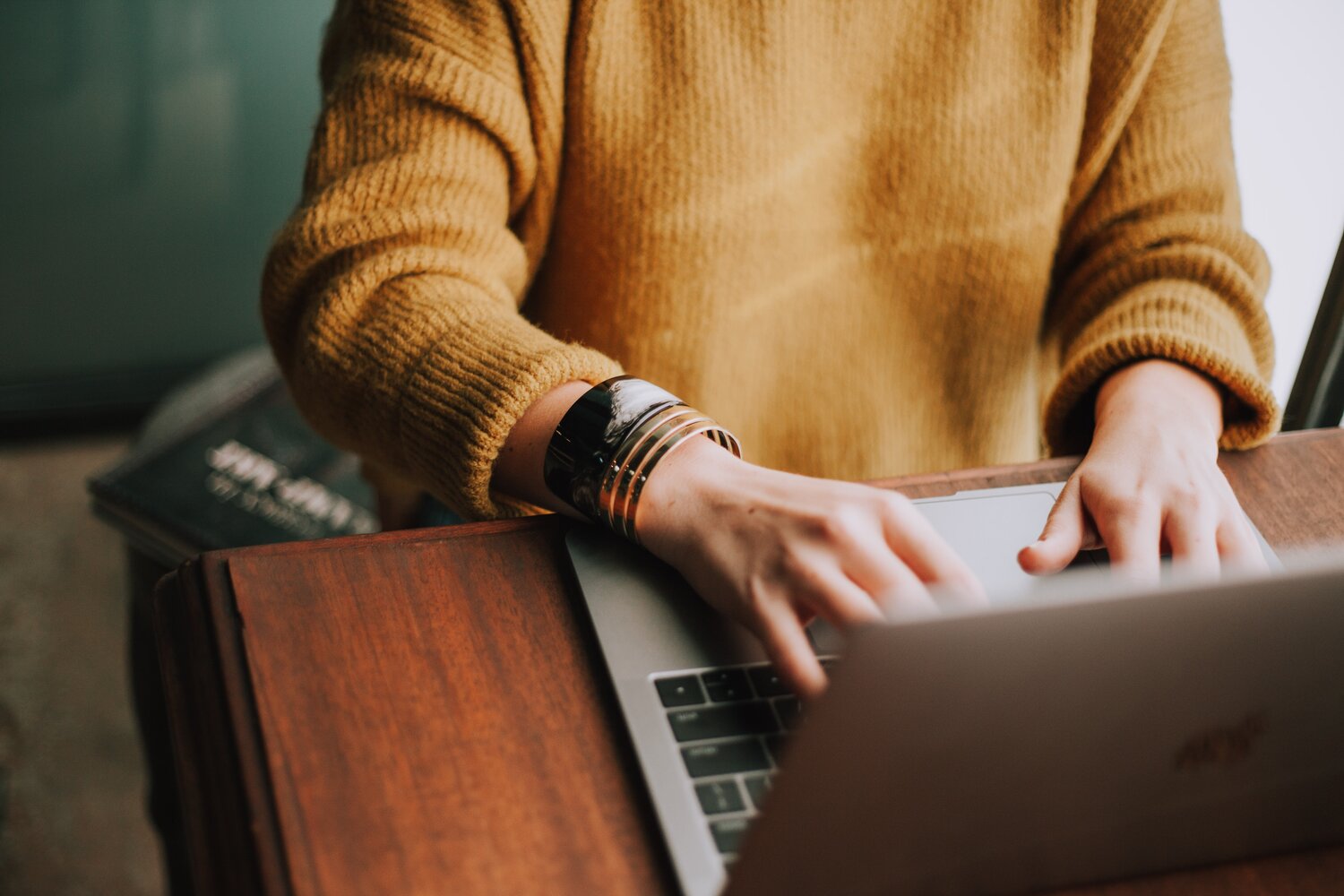 Woman's hands typing on keyboard.