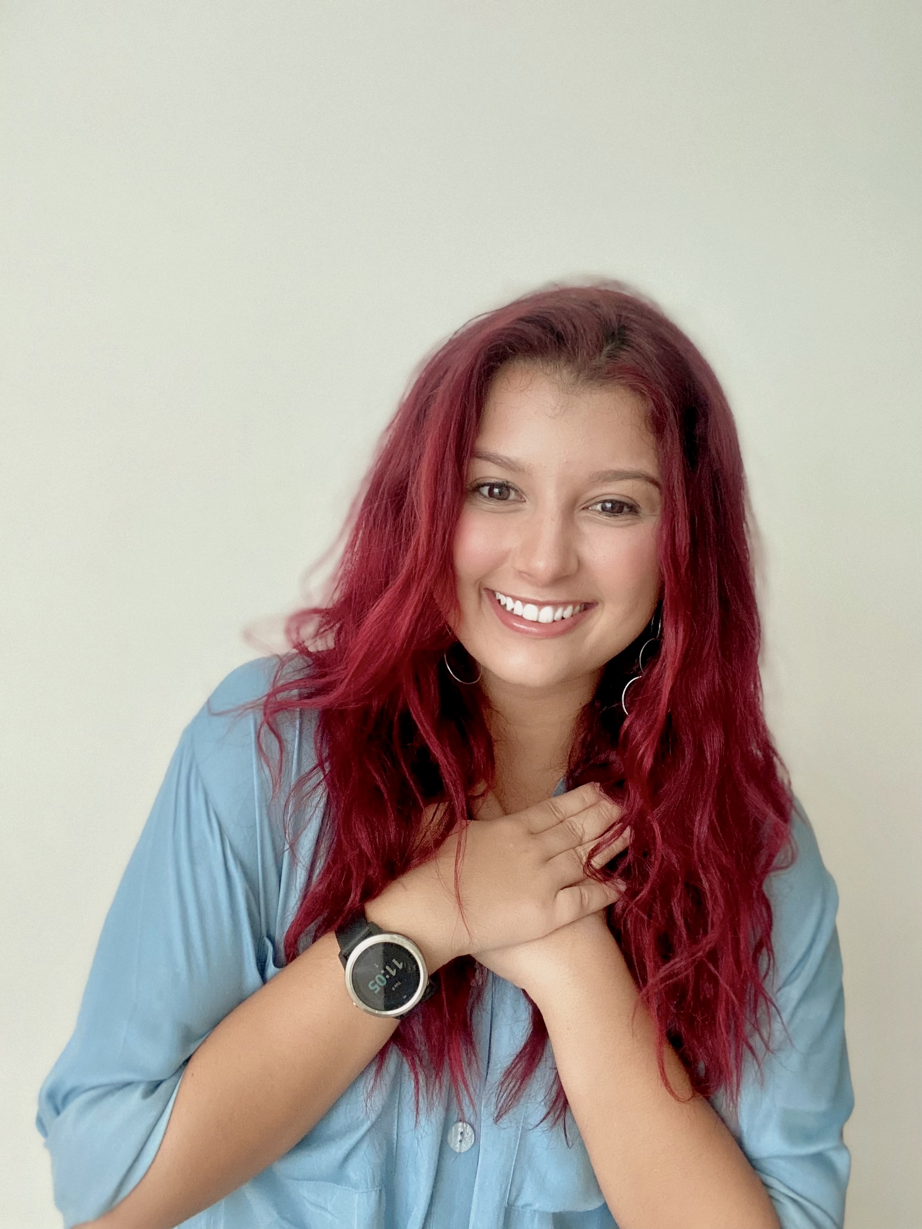 Gabriela Otero, story contributor, has long red hair and is wearing a blue button-up top.