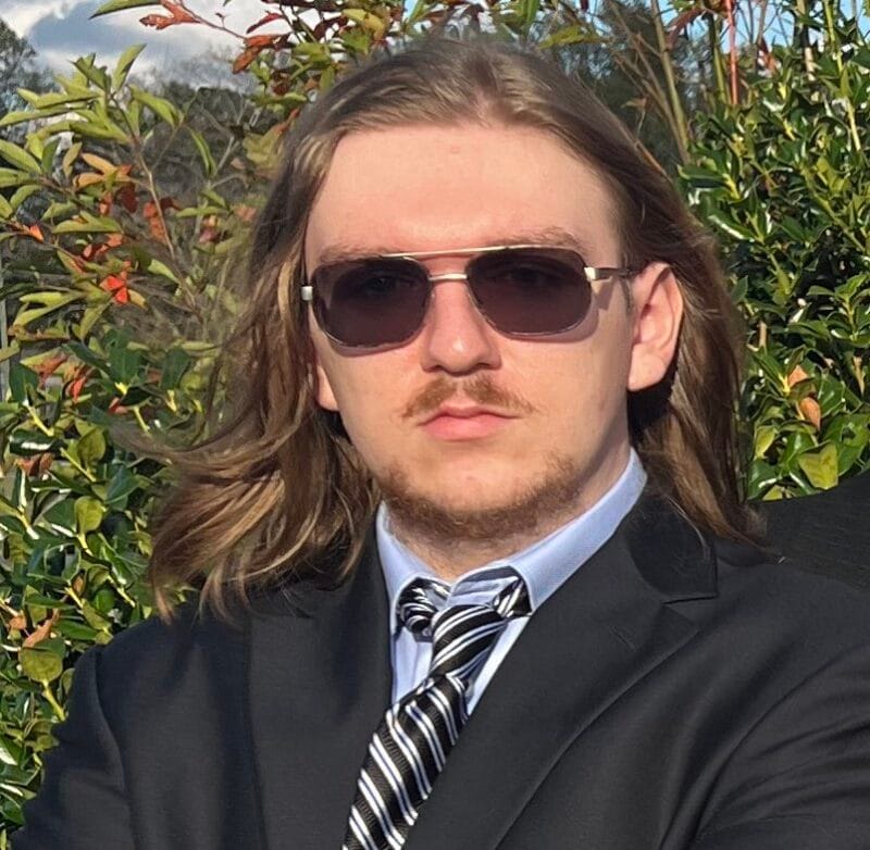 James Reeves headshot standing outdoors.