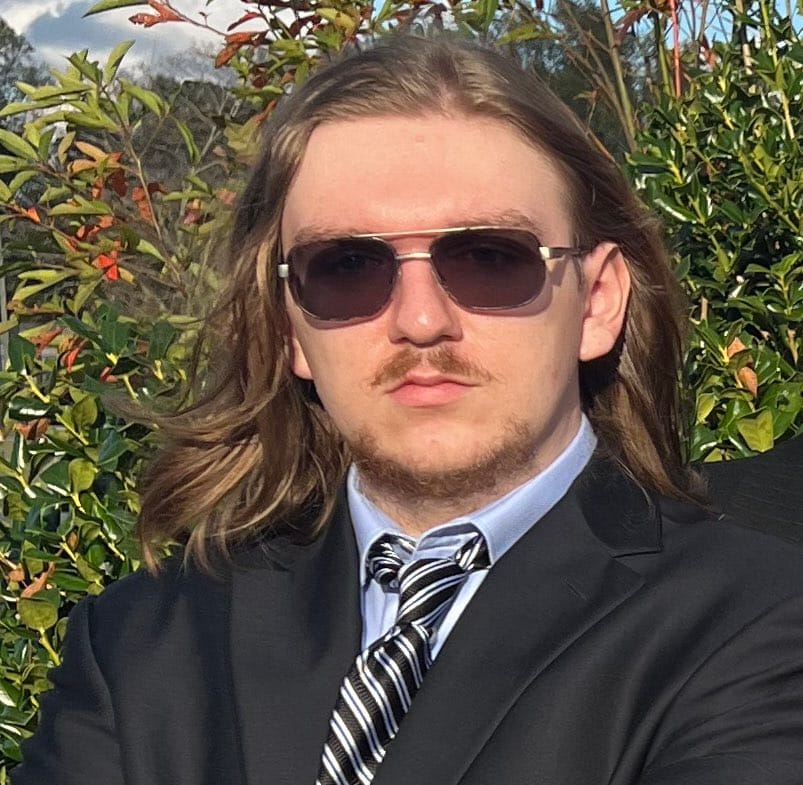 James Reeves headshot standing outdoors.