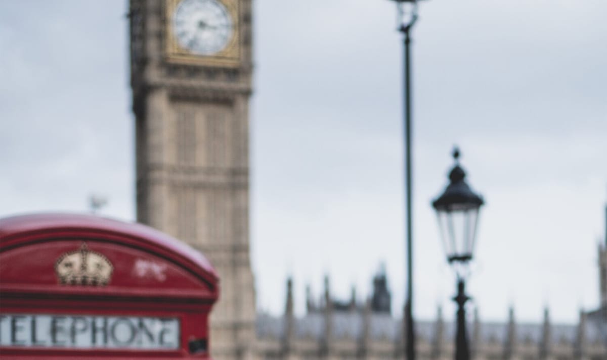 London, with Big Ben in the background and a red telephone booth in the foreground.