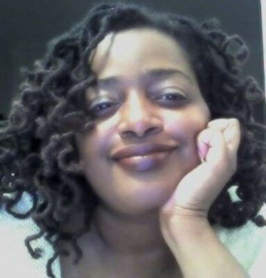 Melissa Moore leaning into the camera, smiling.