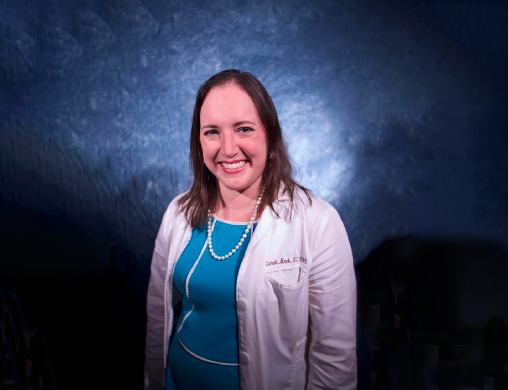 Headshot of Sarah Cook, story contributor, in her medical white coat.