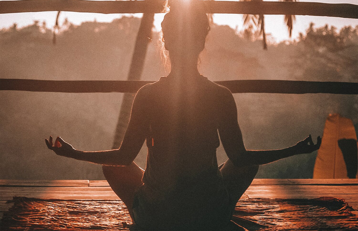 Woman meditating outside.