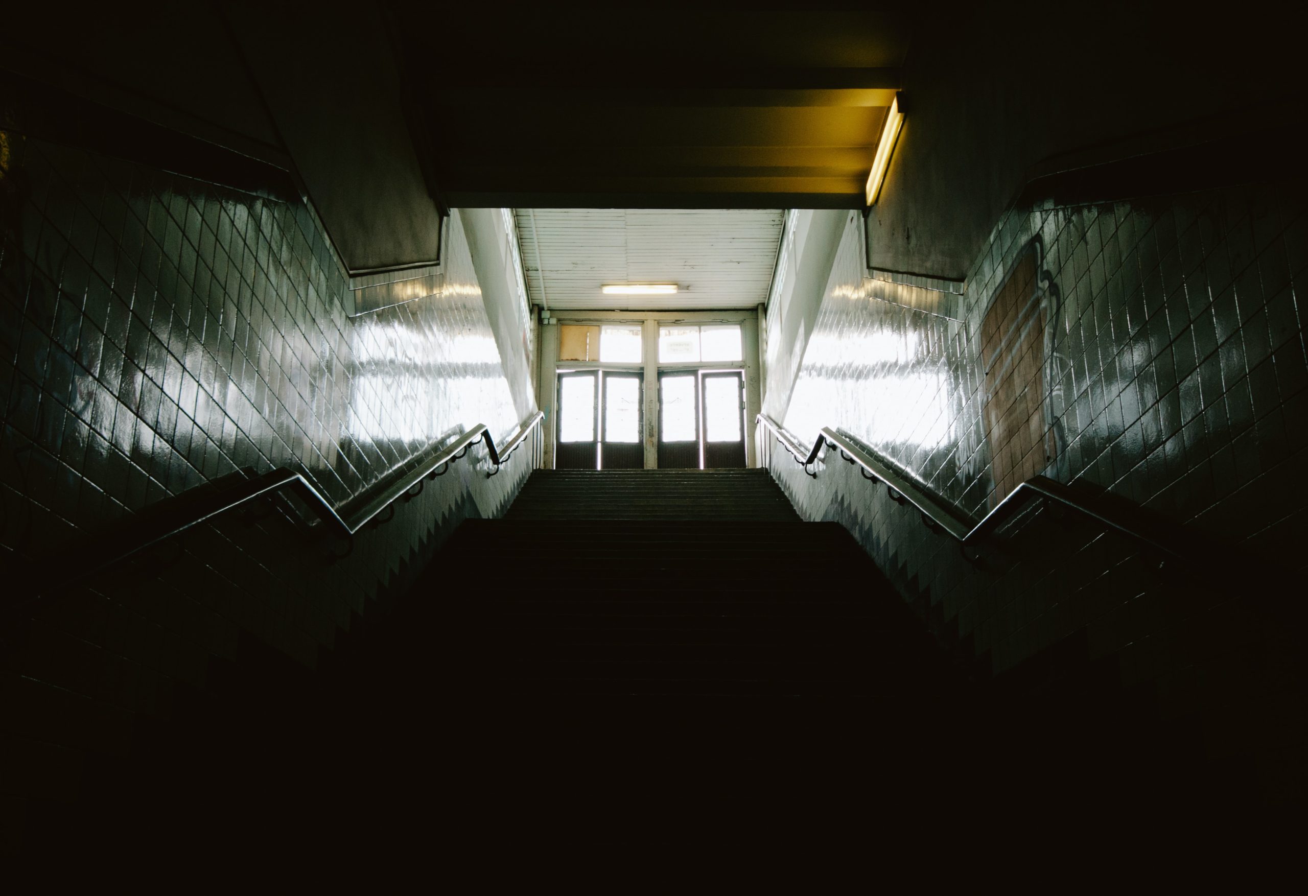 Looking up at a dark stairwell at school.
