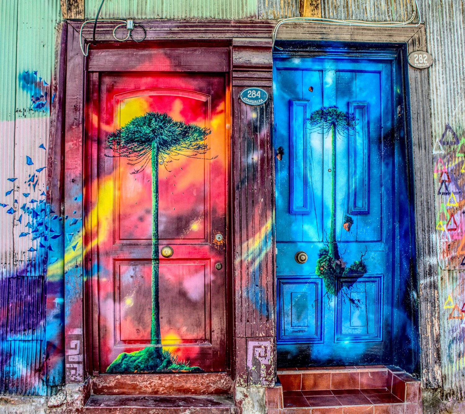 Colorfully painted neighboring doors.