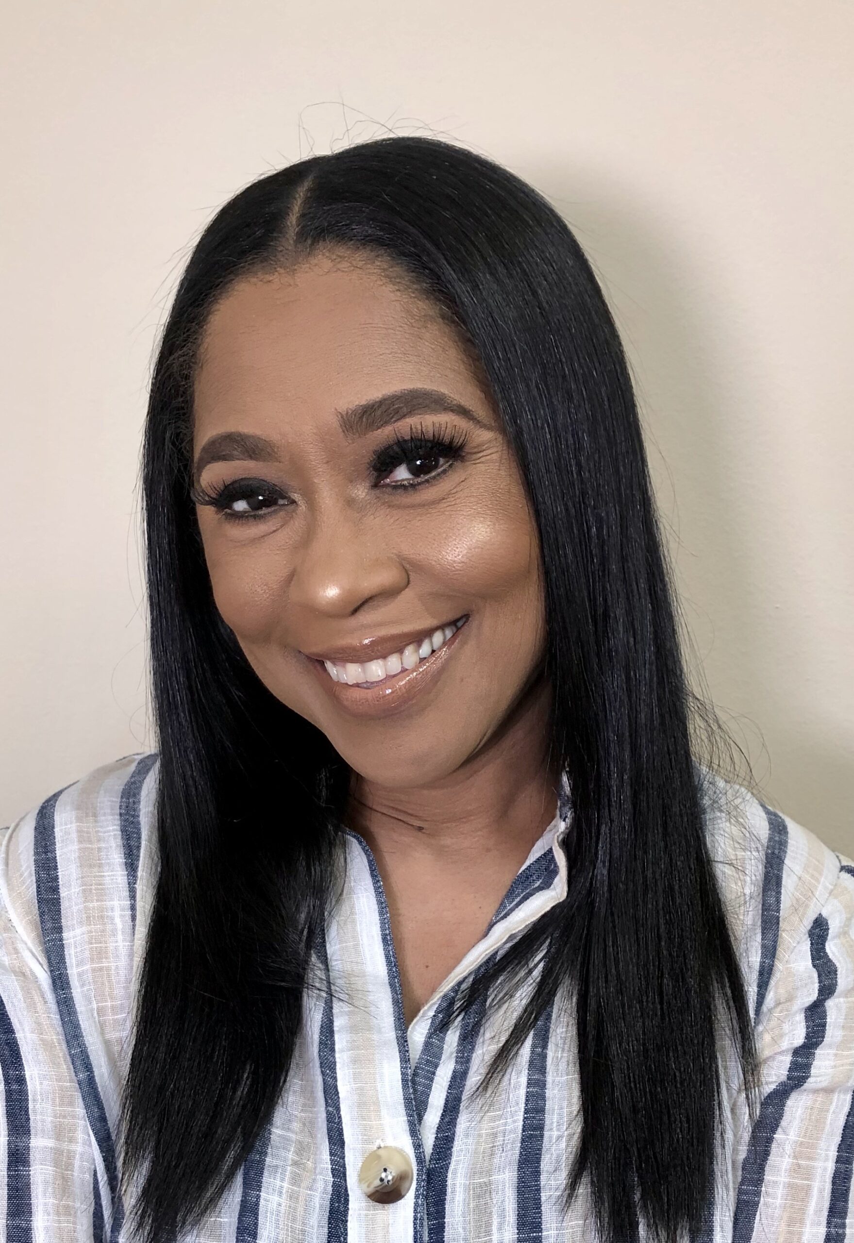 Cynthia Fox Everett, story contributor, wearing a striped button-up top in front of a neutral background.