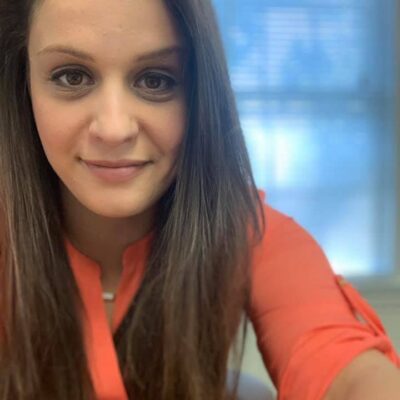 Danielle Glick, story contributor, wearing an orange top.