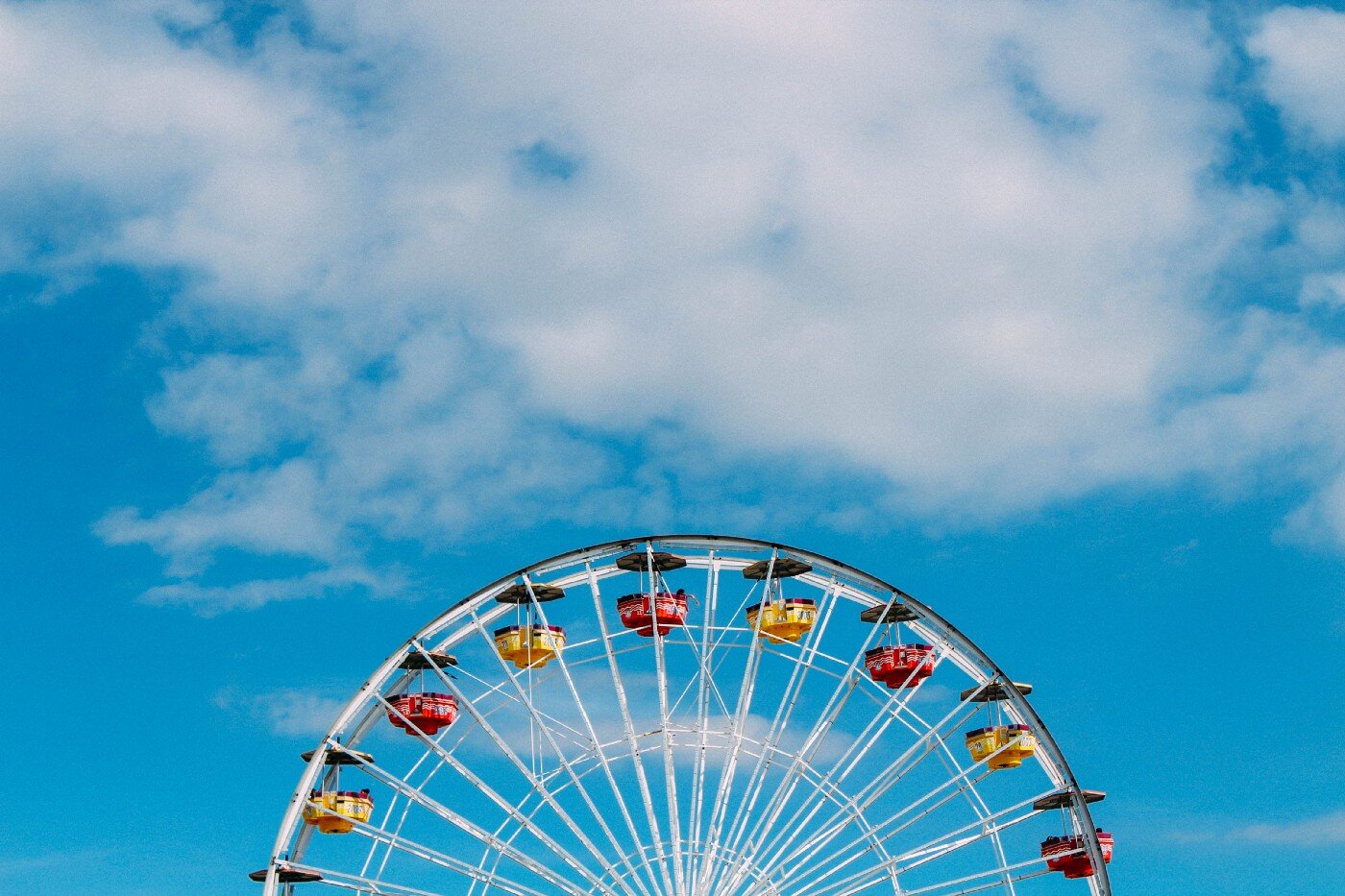 Ferris wheel against a blue sky.