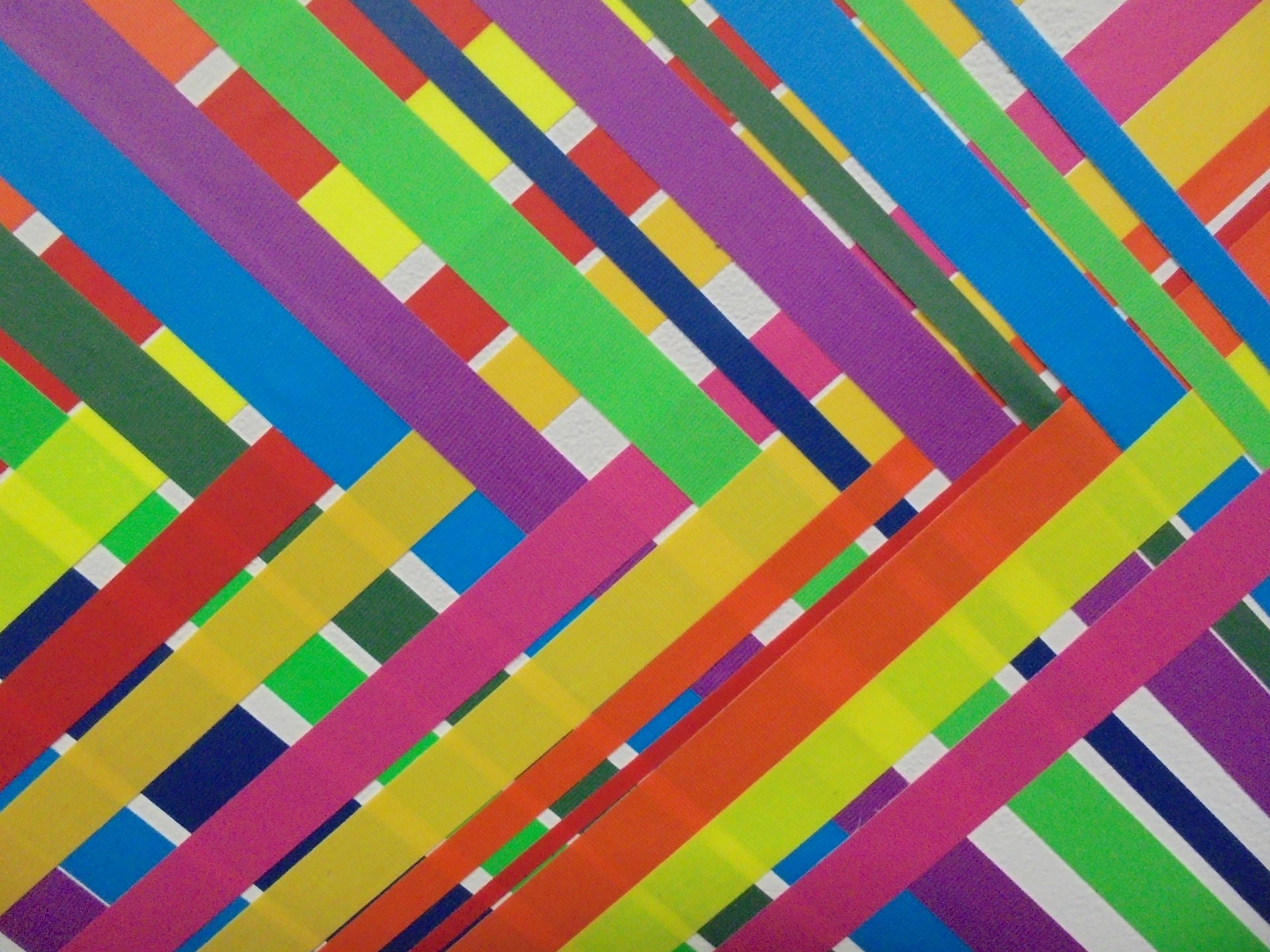 Colorful ribbons crossing one another to create striped art.