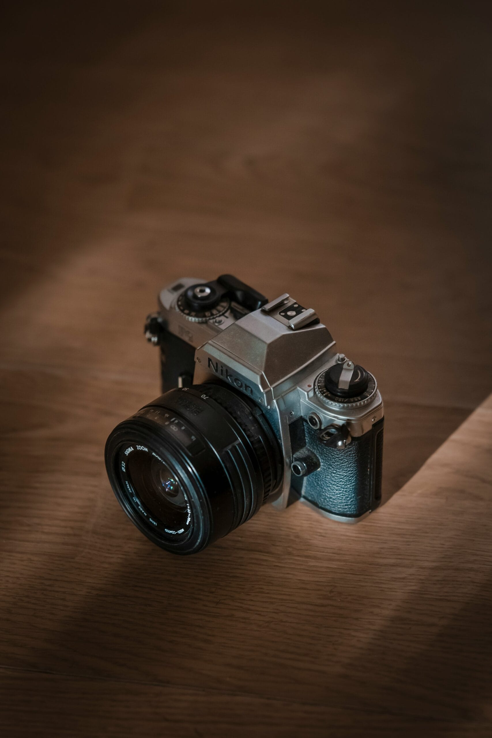 Anonymous contributor image, featuring a camera sitting on top of a wooden table.