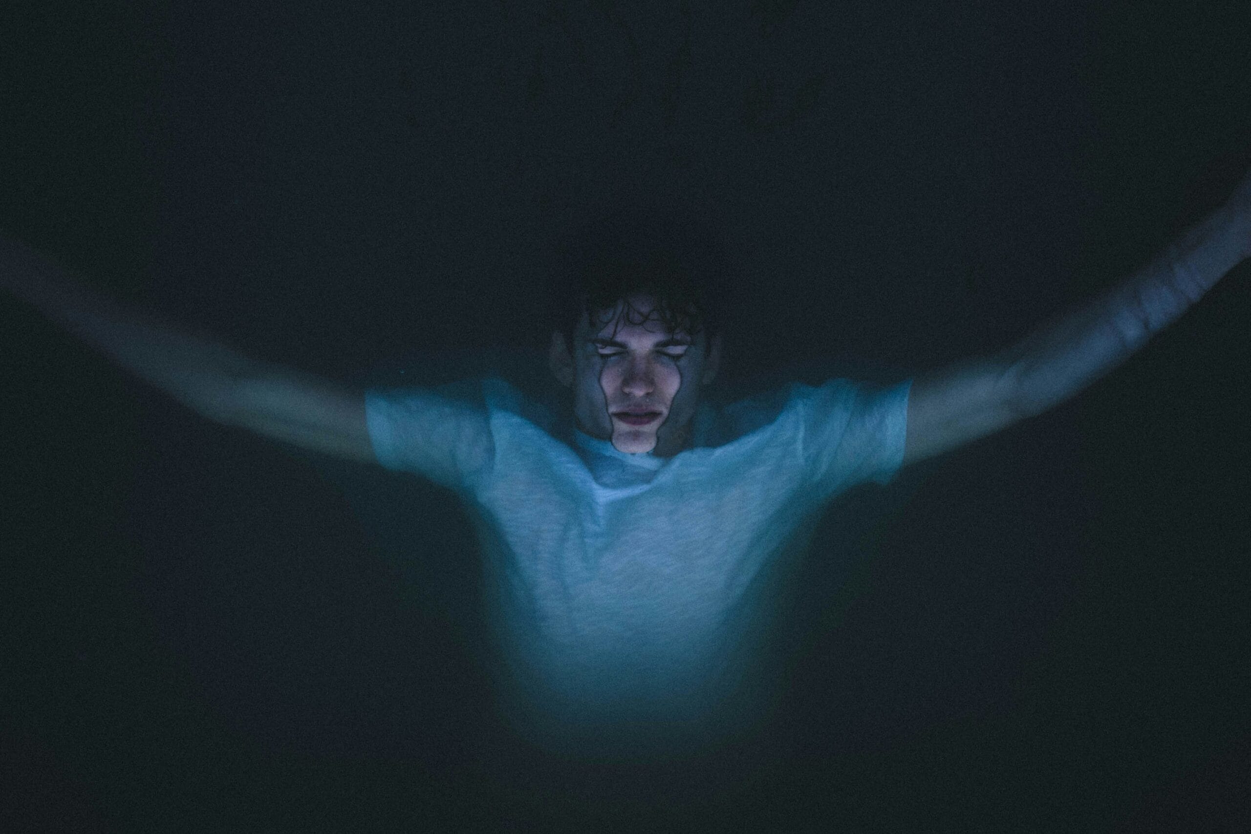 Underwater photo of man laying on top of the water.