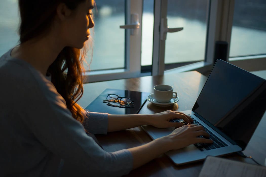 Woman typing on her laptop.