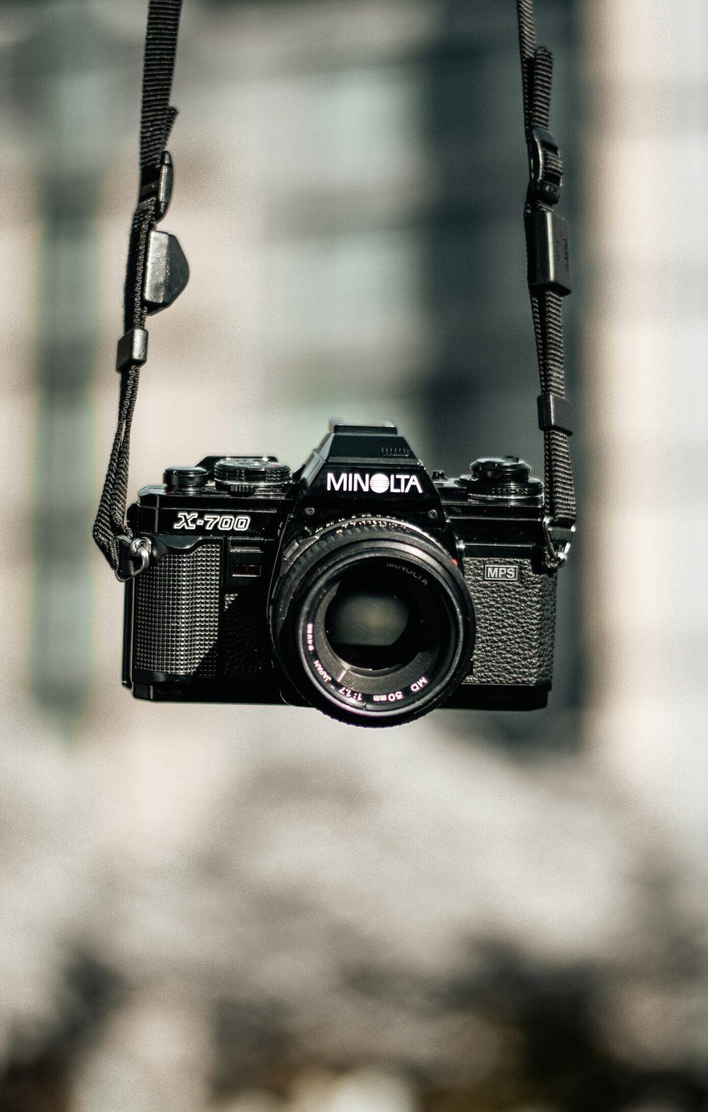 Anonymous contributor image, featuring a black Minolta DSLR camera.